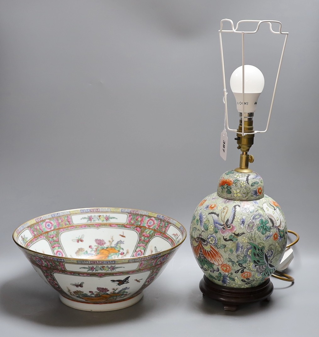 A Chinese famille verte vase converted into a lamp decorated with butterflies amongst botany, together with a famille rose punch bowl with quad-split panel decoration of floral landscapes, 31.5cm diameter